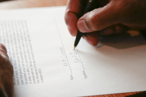 Person Signing Contract - Close-Up