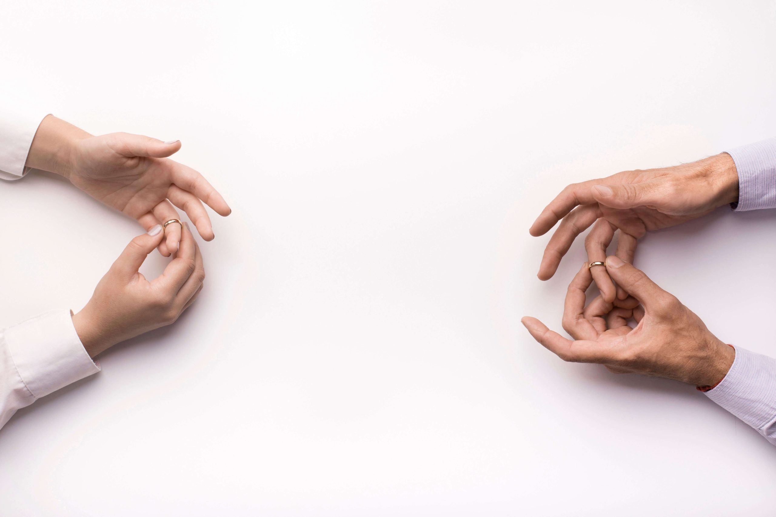 4.-Divorce—shutterstock_1628396077 two pair hands taking off wedding rings